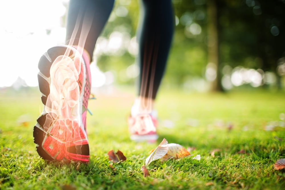 Digital composite of Highlighted foot bones of jogging woman Digital composite of Highlighted foot bones of jogging woman