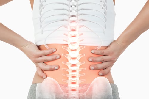 Digital composite of Highlighted spine of woman with back pain