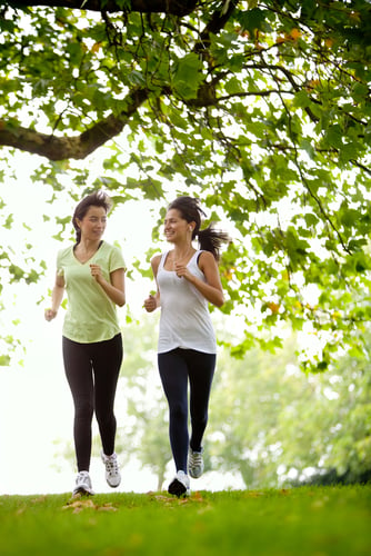 Happy women jogging at the park - fitness concepts