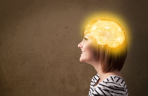 Young girl thinking with glowing brain illustration on grungy background